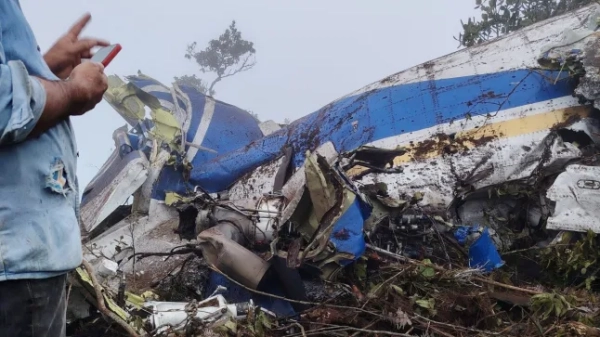 Людина стоїть біля уламків авіакатастрофи в Плайя-де-Белен, Північний Сантандер, Колумбія, 28 січня 2026 року, на цьому фото, отриманому із соціальних мереж.