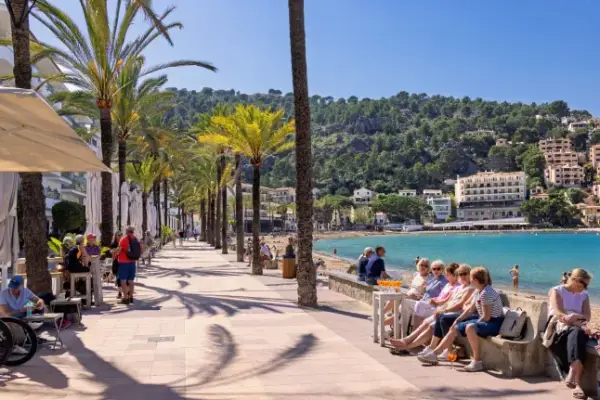 Port de Soller, Mallorca, Spain-April, 2025: Tourists on boardwalk a sunny summer day at Port de S??ller in Majorca