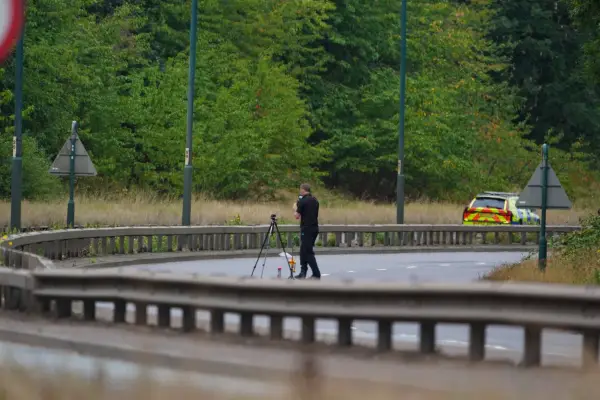 A police officer at the scene of a fatal crash involving a police car and a Volkswagen Passat on the A66 in South Bank, near Middlesbrough.
