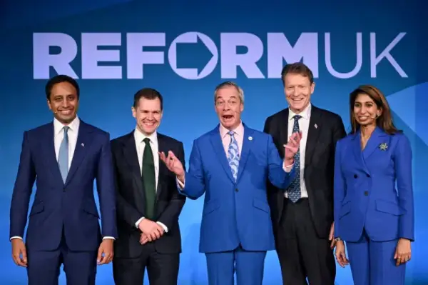 FILE PHOTO: Britain's Reform UK leader Nigel Farage stands with Zia Yusuf, newly announced as the party's Shadow Home Secretary, Robert Jenrick, newly announced as the party's Shadow Chancellor of the Exchequer, Richard Tice, newly announced as the party's Shadow Business, Trade and Energy Secretary, and Suella Braverman, newly announced as the party's Shadow Education and Skills Secretary, in London, Britain, February 17, 2026. REUTERS/Chris J. Ratcliffe/File Photo