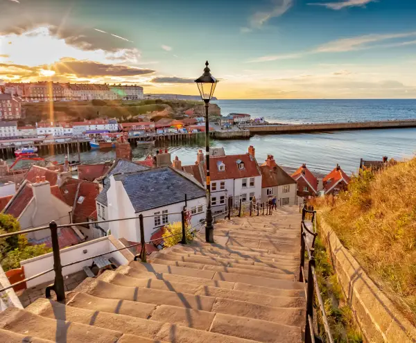Whitby, North Yorkshire Coast, England 24th August 2018: Famous 199 steps at sunset over the harbour at Whitby; Shutterstock ID 1349227880; purchase_order: -; job: -; client: -; other: -