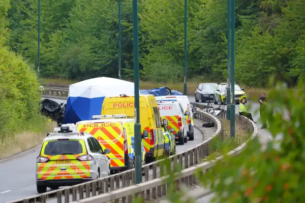 Police officers at the scene of a fatal crash involving a police car and a Volkswagen Passat on the A66 in South Bank, near Middlesbrough.