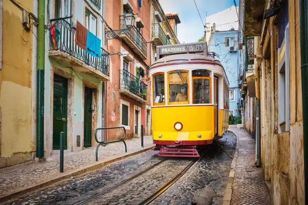 Страйки аеропортів Європи: від Португалії до Італії 9 Famous vintage yellow tram 28 in the narrow streets of Alfama district in Lisbon, Portugal - symbol of Lisbon, famous popular travel destination and tourist attraction; Shutterstock ID 2313513911; purchase_order: -; job: -; client: -; other: