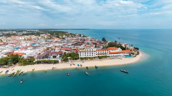 Zanzibar Island, is the main island in the Tanzanian archipelago of Zanzibar. Stone Town, part of Zanzibar City, is an old trade center, with mosques and winding lanes. The 1883 House of Wonders is a former sultan???s palace with a clock tower. The Old Fort now houses a cultural center and a stone amphitheater. Underground aquutrients fed hot water to the late-19th-century Hamamni Persian Baths