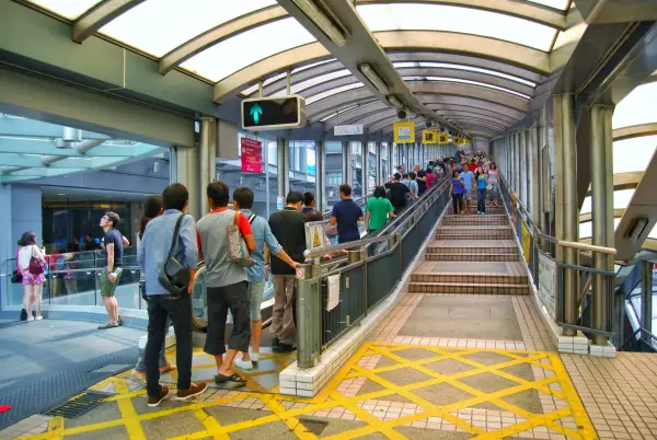Tourist walking on the famous Central???Mid-Levels escalator and walkway. It is the longest outdoor covered escalator system in the world.