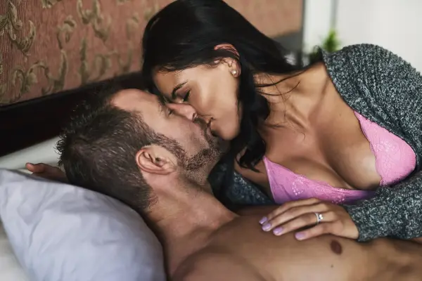 Couple, home and kissing in bed for affection with love, sexual and bonding or trust. People, relationship and smile in lingerie for romance on valentines day, anniversary and sensual with passion; Shutterstock ID 2518830207; purchase_order: -; job: -; client: -; other: