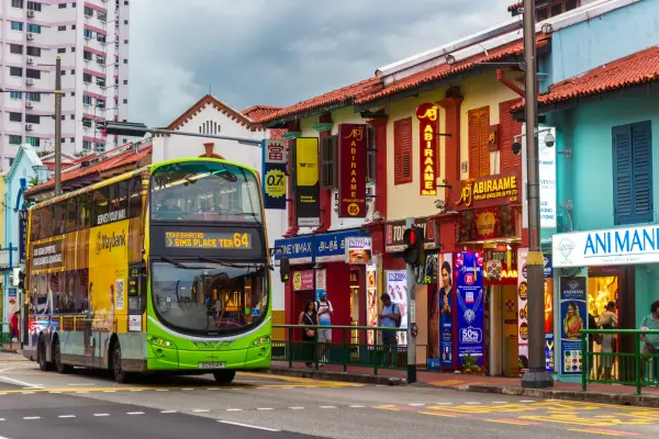 Singapore - 26 December, 2025: modern SBS Transit double-decker bus on Serangoon Roads in the historic Little India, Singapore. View on traditional Singaporean shophouses from the early 20th century