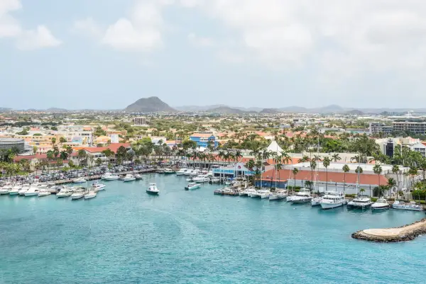 Oranjestad, Aruba - April 11, 2024: Picturesque view of the marina at Seaport Village in Oranjestad, Aruba, featuring yachts, boats, and catamarans.