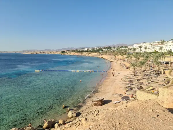 Sun loungers on the sand on the beach by the sea in Sharm El-Sheikh, Egypt.