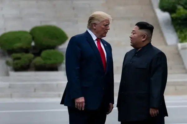 TOPSHOT - US President Donald Trump and North Korea's leader Kim Jong-un stand on North Korean soil while walking to South Korea in the Demilitarized Zone(DMZ) on June 30, 2019, in Panmunjom, Korea. (Photo by Brendan Smialowski / AFP via Getty Images)