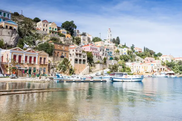 Various colourful boats pictured on the water in Symi's main town seen on